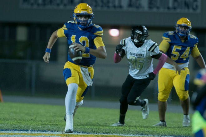 Auburndale's Chad Williams runs for a first down on a quarterback keeper in the first quarter. Auburndale Bloodhounds vs. the Davenport Broncos last season. Williams is now at Lakeland.