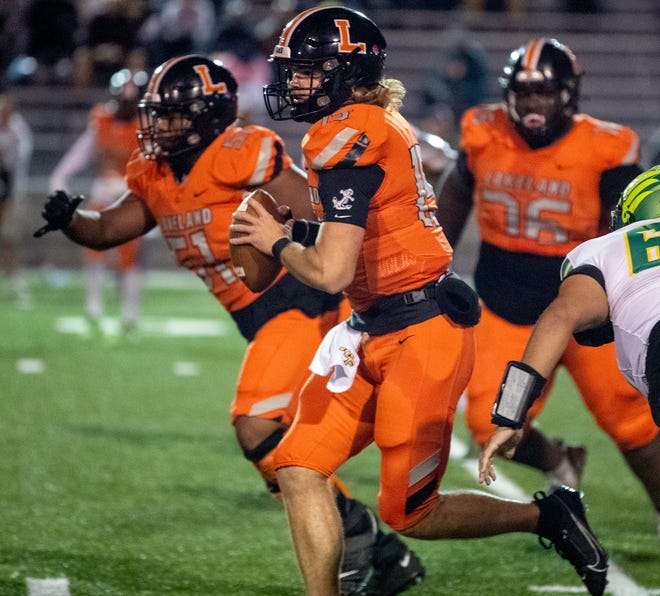 Lakeland quarterback Zander Smith scarmbles for an 11-yard gain against Lake Minneola on Fridayt night in the Class 4S, Region 3 final at Bryant Stadium.