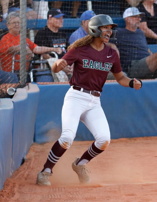 Eagles catcher Olivia Newman (33) celebrates after scoring the first run of the game in the first inning.
