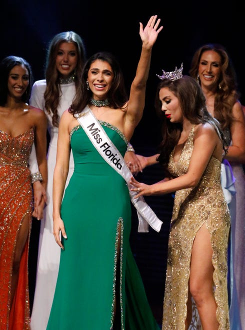Miss Tampa waves to the audience as Miss Florida 2023 Juliette Valle pins the 2024 Miss Florida sash on her at the 2024 Miss Florida Pageant Finals at the RP Funding Center in Lakeland on Saturday June 29, 2024. Fink was also named the recipient of two scholarships on Friday night during the Miss Florida Organization Scholarship Beach Party held at Camp Margaritaville RV Resort and Cabana Cabins in Auburndale, taking the Miss Florida Practical Leadership Scholarship ($500) and the Miss Florida Community Service Initiative Scholarship ($1,500).