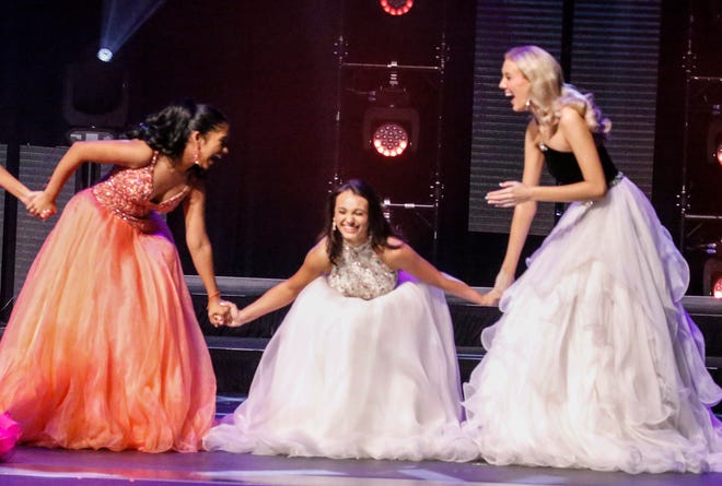 Miss Swan City’s Teen Vaishnavi Rednam, left, and Miss Gainevsille’s Teen Larkin Mainwarning, right, hold on to Ashlee Combee, Miss Polk County’s Teen, after she was announced one of the five finalists at the Miss Florida's Teen Pageant Finals at the RP Funding Center in Lakeland on Saturday, June 29, 2024. Combee was named the fourth runner-up. Burton was the second runner-up.
