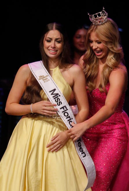 Miss St. Augustine’s Teen Ireland Harkins receives the queen's sash from outgoing Miss Florida’s Teen Anna-Katherine Risalvato before placing the crown on her head at the Miss Florida's Teen Finals at the RP Funding Center in Lakeland on Saturday, June 29, 2024.